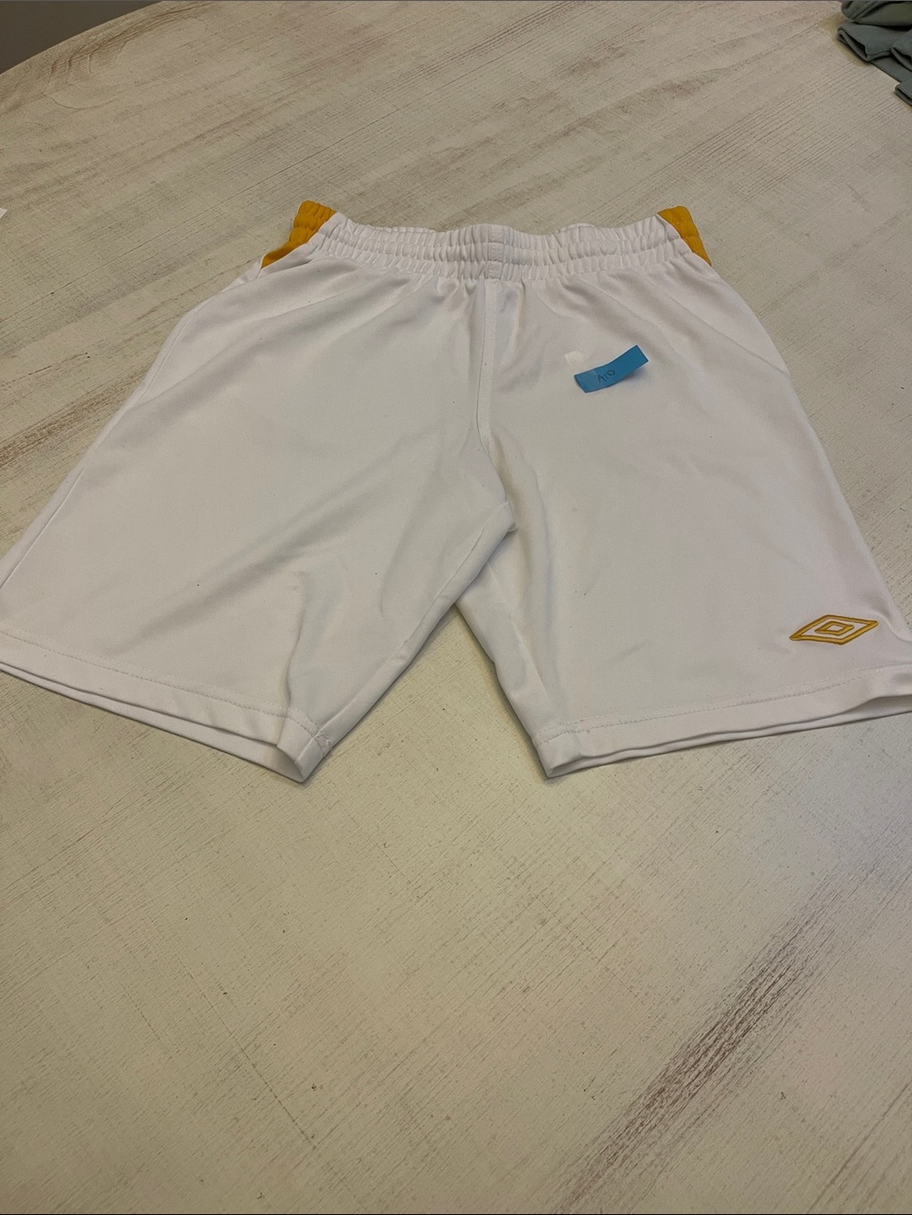Umbro Men’s White Athletic Shorts with Gold Logos